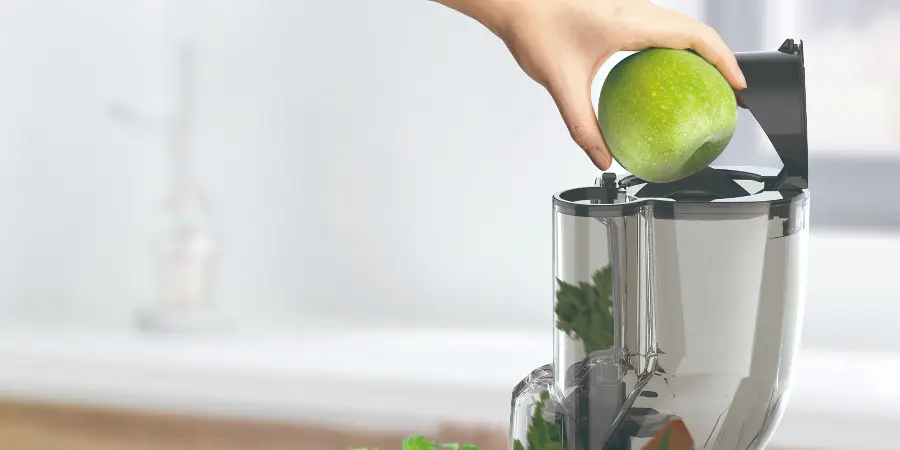 The juicer with a double feed opening for different sizes of fruits and vegetables